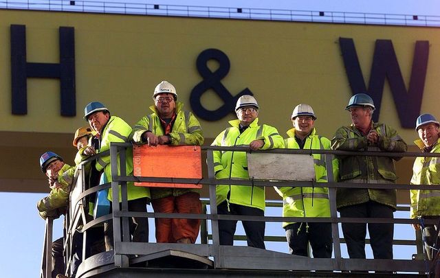 Harland and Wolff shipyard workers look on as the Anvil Point, the last ship to be built at the Belfast shipyard, is named in a ceremony on January 17, 2003, in Belfast, Northern Ireland. 