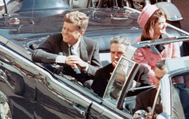 President John F Kennedy and his wife Jackie greeting the crowds from their motorcade on that fateful day in Dallas. 
