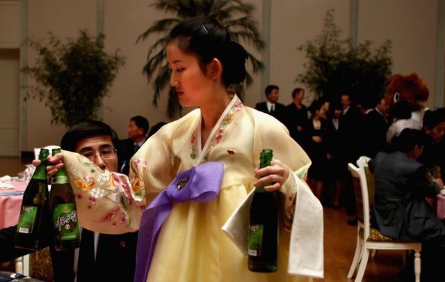 North Korean waitresses distribute beer during an official reception on April 2, 2011, in Pyongyang, North Korea. Pyongyang is the capital city of North Korea and the population is about 2,500,000. 