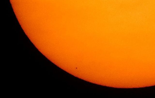 In this NASA-provided image, planet Mercury is seen in silhouette, low center, as it transits across the face of the Sun on November 11, 2019, from Washington