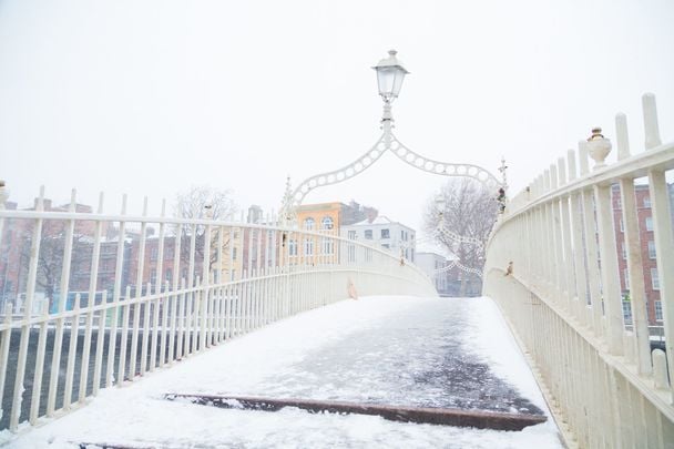 The Ha\'penny bridge covered in snow and ice in Dublin City, Ireland. \n