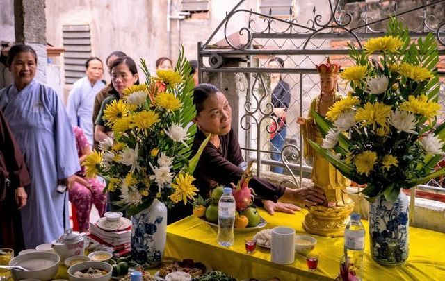 Family members and neighbors of Pham Thi Tra My, who has since been identified as one of the victims, attend a praying ceremony with Buddhist monks in front of a makeshift shrine her house on October 28, 2019 in Ha Tinh province, Vietnam. 