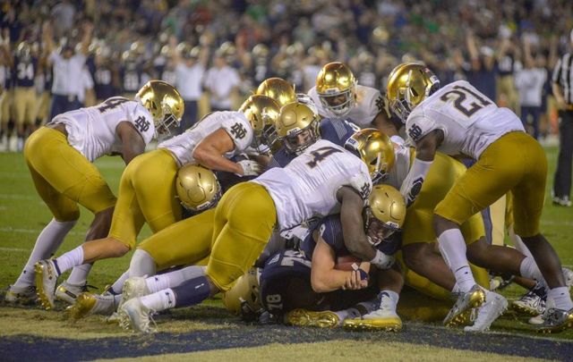 Zach Abey #9 of the Navy Midshipmen carries the ball across the goal line scoring a touchdown in the 2nd half against the Notre Dame Fighting Irish at SDCCU Stadium on October 27, 2018, in San Diego, California.