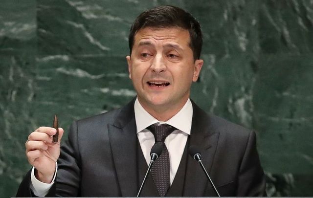 President of Ukraine Volodymyr Zelensky holds up a bullet as he addresses the United Nations General Assembly at UN headquarters on September 25, 2019, in New York City. 