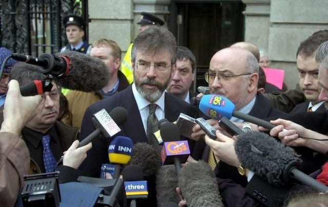 Feb 10, 2005: Sinn Fein President Gerry Adams (L) and TD Caoimhghin O Caolain, speaking to the media outside Leinster House, Dublin in response to the report from the Independent Monitoring Commission, and its main conclusion that the IRA was responsible for the Northern Bank raid. 