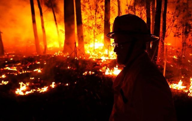A firefighter battles flames in Australia.