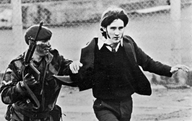 January 30, 1972: A British paratrooper takes a captured youth from the crowd on \"Bloody Sunday,\" when British paratroopers opened fire on a civil rights march in Derry.