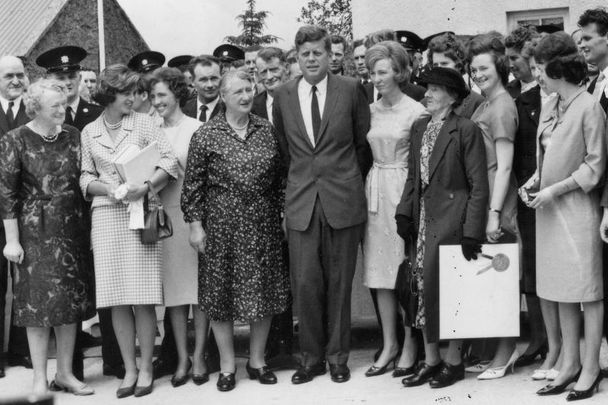 1963: US President John F Kennedy poses with a crowd during his visit to Ireland.