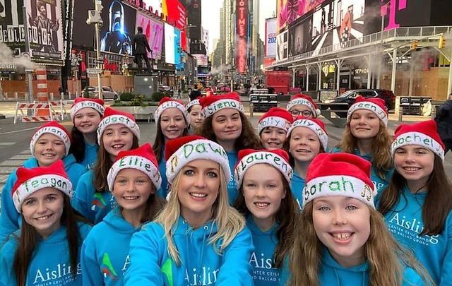Irish music teacher Dawn Ní Dhochartaigh with her New York-based students in Times Square.