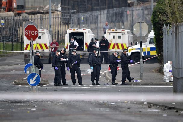 Police investigate the crime scene, Apr 2019, following the murder of Lyra McKee by the New IRA.