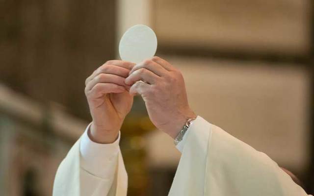 Father Pat Ward from Kilcassalagh, in County Donegal, sings to an empty church.