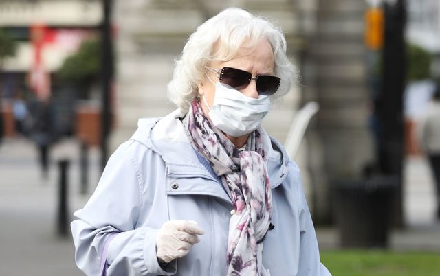 Woman wearing a facemask in St. Stephen\'s Green, in Dublin.