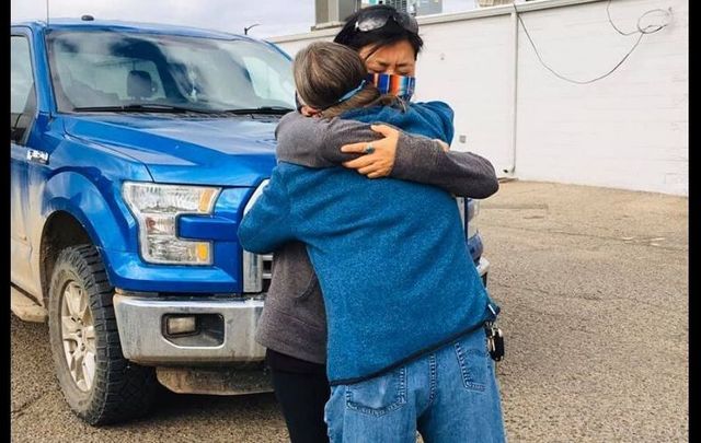 Claudia Morris embraces Ashlee Lewis of Compassionate Colorado after donating a water tank and trailer for the Navajo Nation.