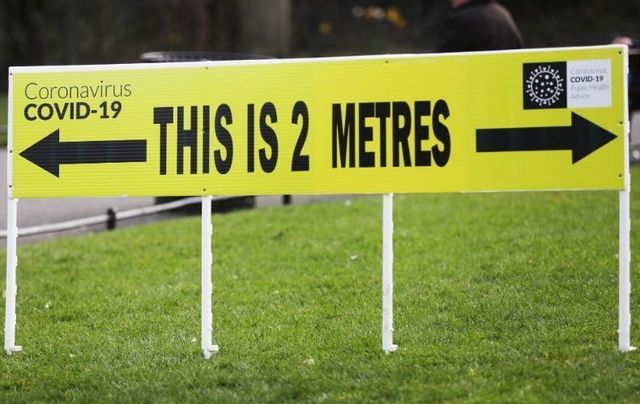 A sign showing the distance of 2 meters to help people with social distance issues in St Stephen’s Green in Dublin on March 25, 2020.