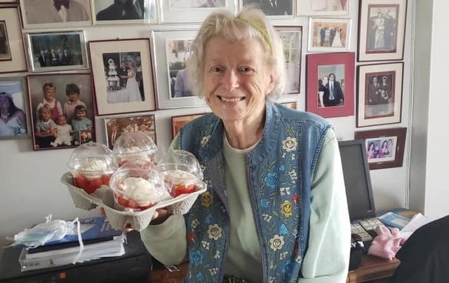 A member of the Aisling Irish Center\'s \'Young at Heart\' group receiving a meal delivery organized by the community center.