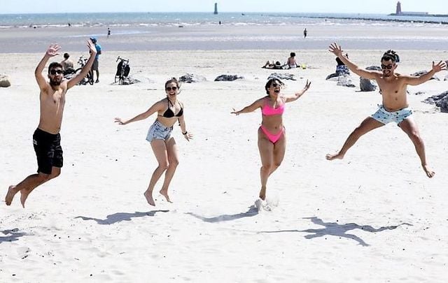 Felipe Chegan from Brazil, Thais Rosa from Brazil, Yasmin Franco from Brazil and Felipe Cardona from Columbia enjoying the good weather and sunshine on Dollymount Strand in Dublin on May 28, 2020.