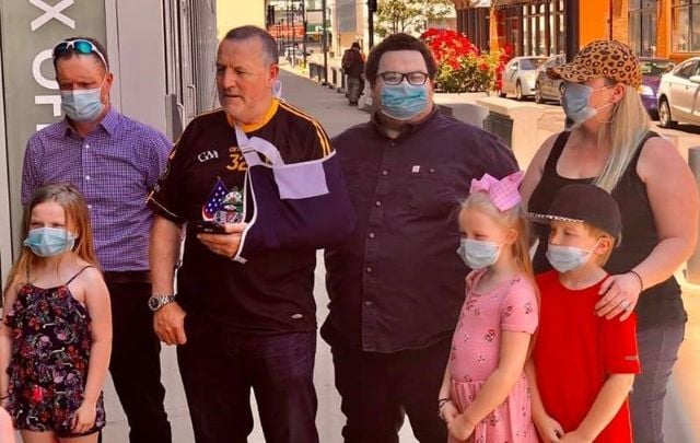 Malachy McAllister (second from left) was met by dozens of supporters before he surrendered himself to authorities in Newark, New Jersey on June 9.
