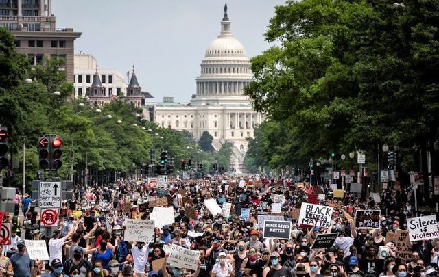 Demonstrators march down Pennsylvania Avenue during a protest against police brutality and racism on June 6, 2020, in Washington, DC. 