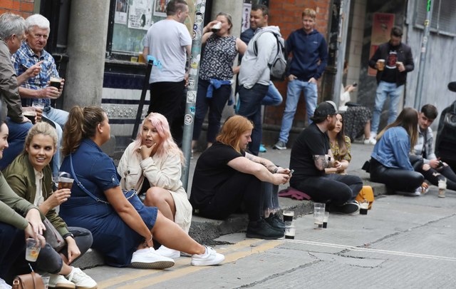 People drinking outside a pub on Dame Court in Dublin on Saturday afternoon.