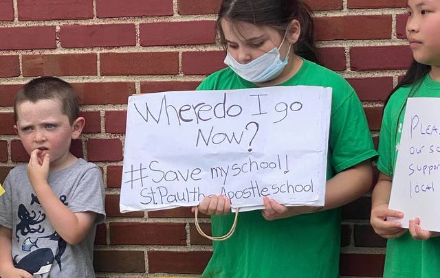 Children outside St. Paul’s on Saturday, rallying to save their school.