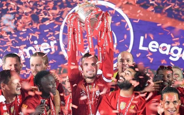 Liverpool captain Jordan Henderson lifts the Premier League trophy at Anfield. 