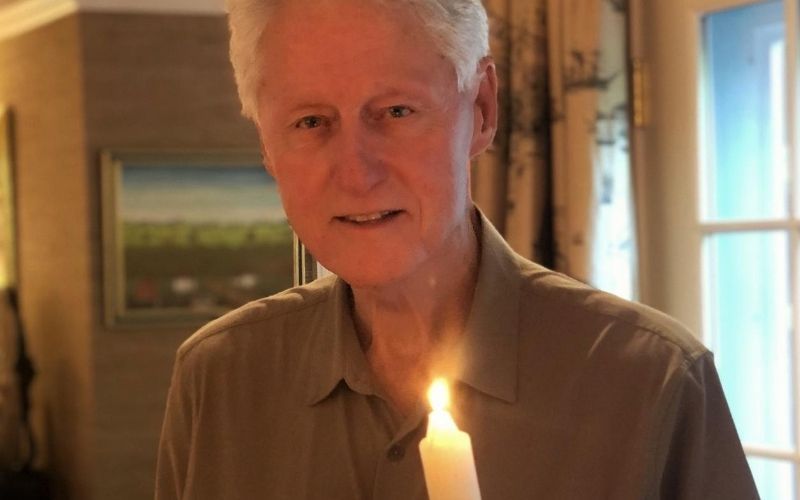 Bill Clinton lights a candle of peace for his hero John Hume 