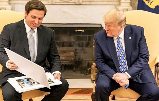 April 28, 2020: President Donald J. Trump looks at diagrams and photos during his meeting with Florida Gov. Ron DeSantis.