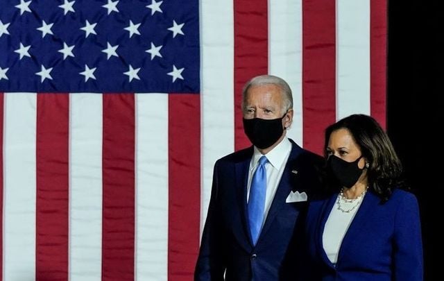 Joe Biden and Kamala Harris arrive to deliver remarks at the Alexis Dupont High School on August 12, 2020, in Wilmington, Delaware.