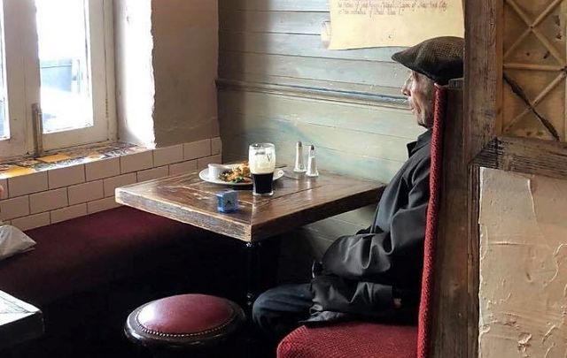 An elderly man pictured with an alarm clock while having a pint in a Galway pub has gone viral online.