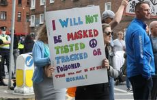 Thousands of anti-mask protesters march in Dublin as top doctor claims flu more harmful