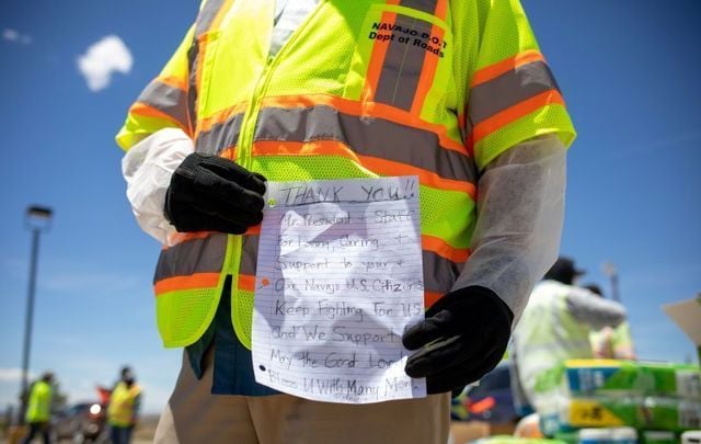 May 27, 2020: Navajo Nation President Jonathan Nez holds a letter of thanks he received from a family as he distributes donations.