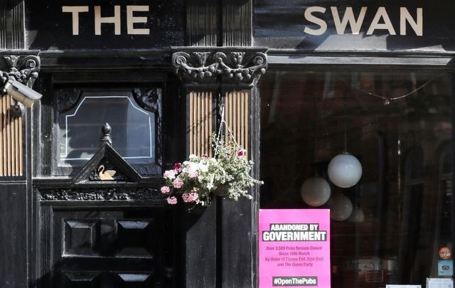 September 15, 2020: The Swan bar in Dublin with a sign outside that reads \"Abandoned by Government\" and \"#OpenThePubs\"