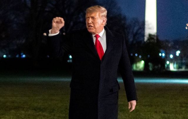 January 12, 2021: President Donald J. Trump gestures to White House staff with a fist pump after disembarking Marine One on the South Lawn of the White House.