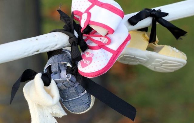 October 2020: Baby shoes hang from a railing at Aras an Uachtarain as part of a protest against calling on President Michael D.Higgins not to uphold the controversial Mother and Baby Homes legislation.