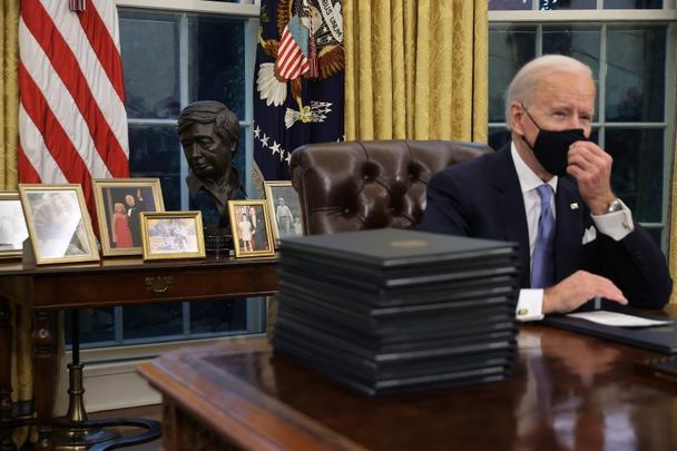 January 20, 2021: President Joe Biden in the Oval Office with a bust of Cesar Chavez in the background flanked by Biden family pictures.