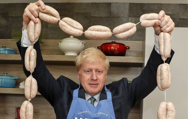 July 4, 2019: Boris Johnson holds up a string of sausages around his neck during a visit to Heck Foods Ltd. headquarters, as part of his Conservative Party leadership campaign tour near Bedale, United Kingdom.