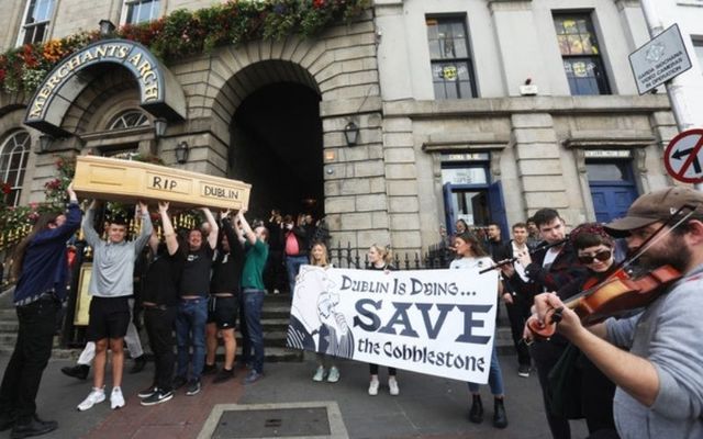 Protesters carry a coffin with the words \"RIP Dublin\" inscribed on it at Merchant\'s Arch in Temple Bar. 