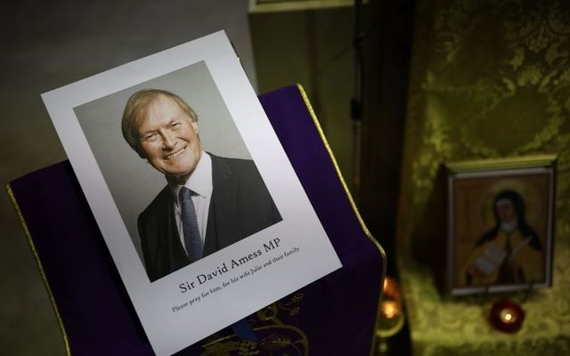 An image of Sir David Amess is displayed at a vigil at St. Peter\'s Catholic Church in England. 