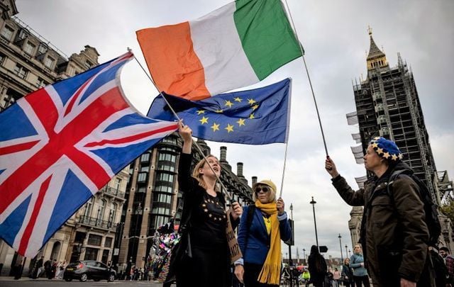 October 13, 2021: Anti-Brexit protesters wave the flags of the United Kingdom, Ireland and European Union outside Parliament in London, England