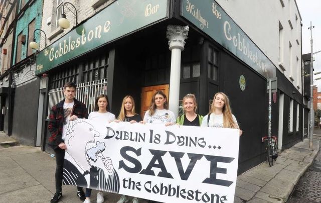 October 9, 2021: Protesters with Meabh Mulligan with a placard outside of The Cobblestone Pub in Dublin during a protest to save the pub. 