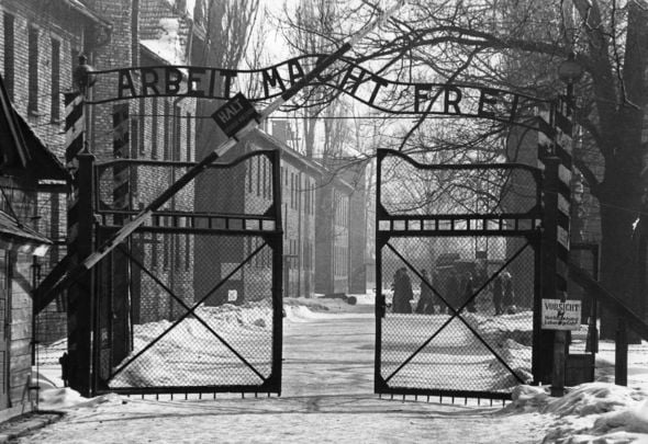 The gates of the Nazi concentration camp at Auschwitz, Poland, circa 1965. The sign above them is \'Arbeit Macht Frei\' - \'Work Makes You Free\'. 