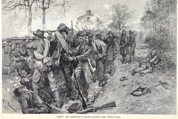 Confederate troops commanded by Generals Cobb and Kershaw fire at attacking Union soldiers from behind a stone wall during the Battle of Fredericksburg.