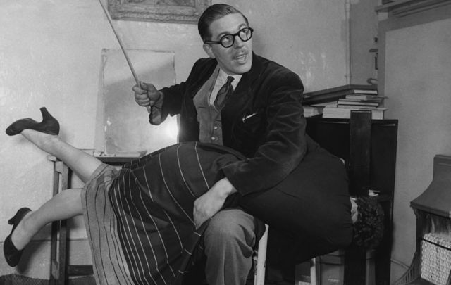 Eric Wildman, demonstrating his \'over the knee position with the help of a female volunteer, circa 1950. Wildman was the founder of the National Society For The Retention Of Corporal Punishment.
