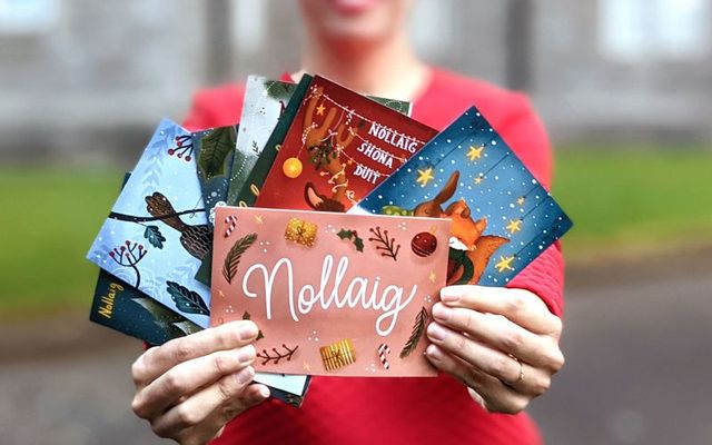 Tarsila Krüse holds the Irish language Christmas cards she designed for Gaelscoil Áine.