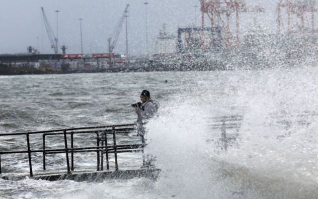 A photographer braves the conditions at Clontarf in County Dublin. 