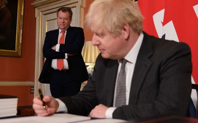 UK chief negotiator David Frost looks on as Prime Minister Boris Johnson signs the Brexit trade deal with the EU in number 10 Downing Street in London on December 30, 2020.