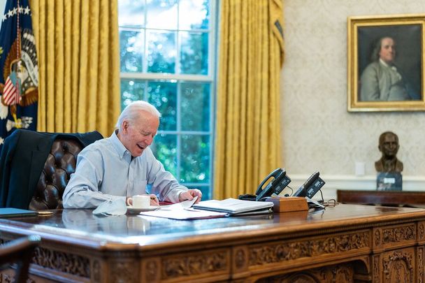 President Joe Biden talks on the phone with British Prime Minister Boris Johnson Saturday, Jan. 23, 2021, in the Oval Office.