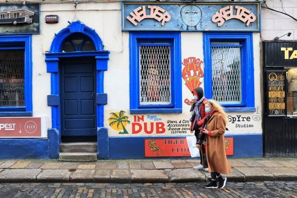 Masked pedestrians walking in Dublin.