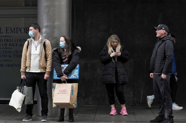 February 28, 2022: Passengers with and without face masks waiting for a Luas tram at the Red Line at Jervis Street Dublin. Today is the first day it\'s not compulsory to wear masks on public transport. 
