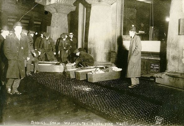 Coffins of some of the 146 people who lost their lives in the Triangle Shirtwaist Factory Fire, of 1911, lie on the sidewalks